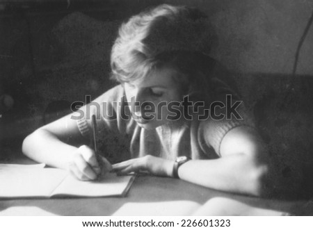 JASLO,POLAND - CIRCA 1970 : vintage photo of schoolgirl writing her exercise