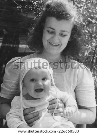 KROSNO,POLAND - CIRCA 1945 : vintage photo of mother with her baby