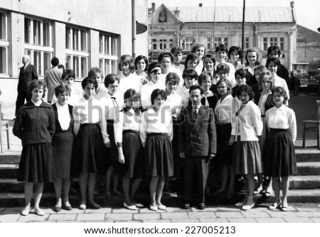 JASLO,POLAND - CIRCA 1962: vintage photo of school-girls in class with their teacher before completed secondary education
