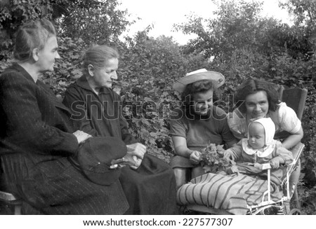 KROSNO, POLAND CIRCA 1945 : vintage photo of baby with her grandmothers,mother and aunty