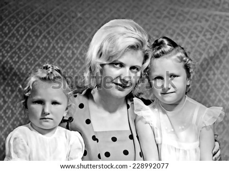 JASLO,POLAND - CIRCA 1959 : vintage photo of young mother with her two daughters
