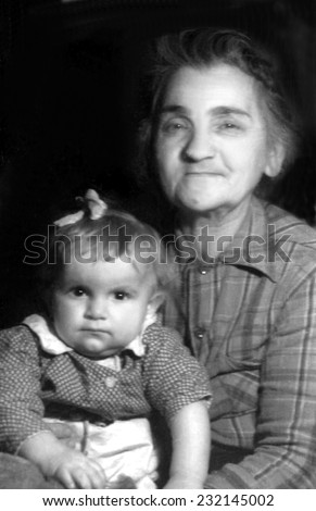 KROSNO,POLAND - CIRCA 1946 : vintage photo of Grandmother with her small grandaughter
