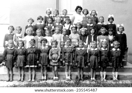 JASLO,POLAND - CIRCA 1958:vintage photo of schoolgirls with their teacher