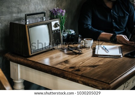 Old television on wooden table decorated in coffee shop,Retro TV technology