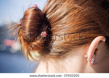 Girl brown hair bun with jewelers