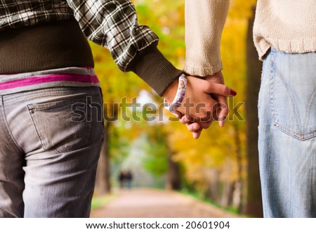 Young couple holding each other hands close-up
