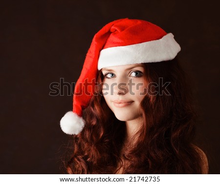 Young beautiful girl in santa claus hat