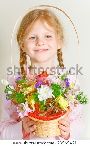 Small girl with a basket of flowers in her hands