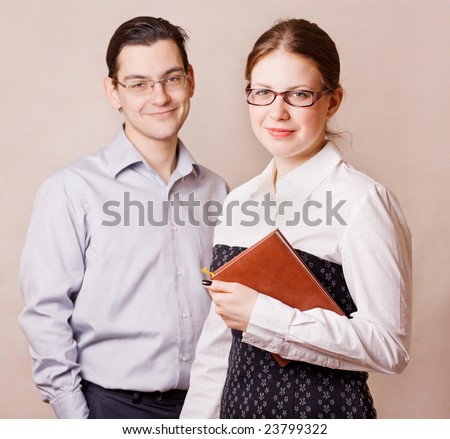 Young man and woman standing side my 