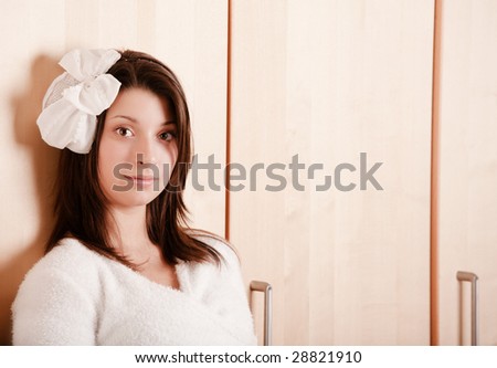 Pretty young girl with a bow in dark hair