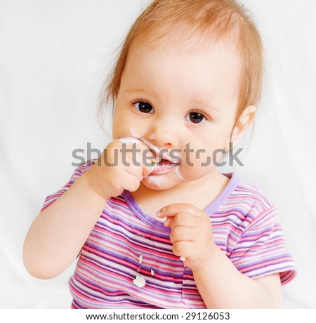 Small girl eating some food with hands