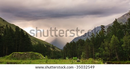 Beautiful mountain cloudy landscape with green grass