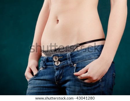 Slim girl stomach in blue jeans