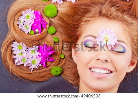 Pretty girl  lying with flowers portrait