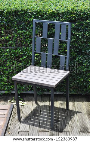 alone chair with green plant background