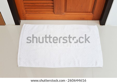white welcome doormat