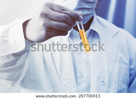 researcher holding science test tube ,pharmaceutical background
