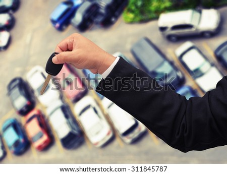 business man hand holding car key