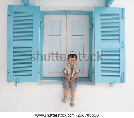 Boys 3-4 years old, sitting Window, be happy, Asia, Thailand.