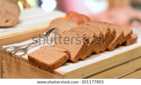 Sliced bread on wooden box shelf for buffet line