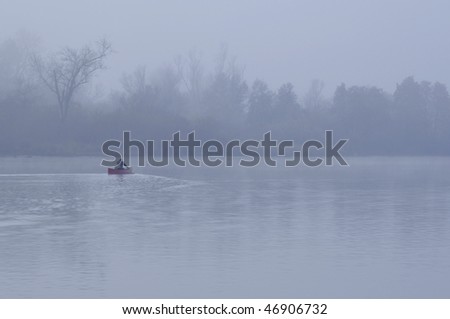 Man Kayaking In Fog On American River