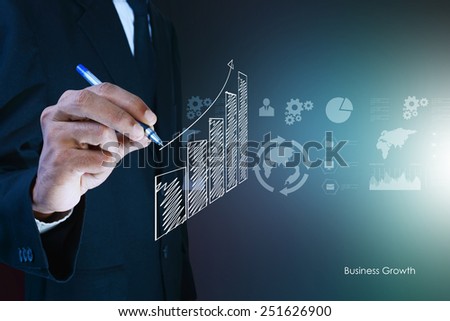business man drawing growth graph