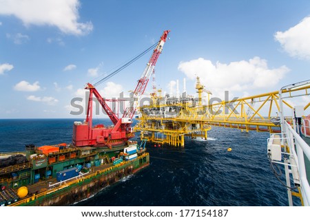 Large crane vessel installing the platform in offshore,crane barge doing marine heavy lift installation works in the gulf or the sea