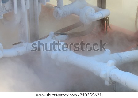 Ice on tubing when supply nitrogen to process, Container with liquid nitrogen, lot of vapour, cool ice on tube in industry jobs.