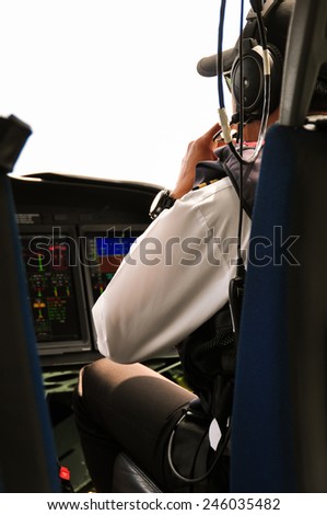 Pilot and copilot in corporate plane in cockpit, Pilot operation with control panel.