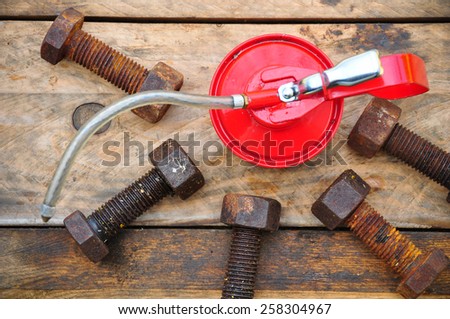Oil can on wooden background, Lube oil can and used in industry or hard works.