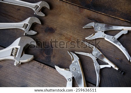 Adjustable wrench or spanner wrench and Locking pliers on wooden background, Prepare basic hand tools for work.