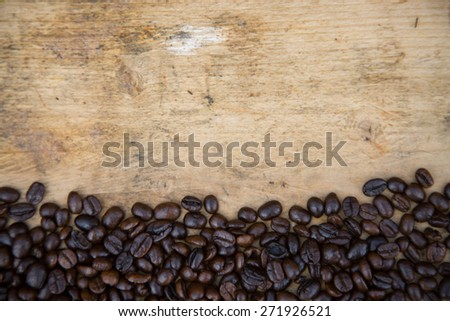 Coffee beans background on wooden, Fresh coffee beans with coffee cup on wooden background, Drinking set background.