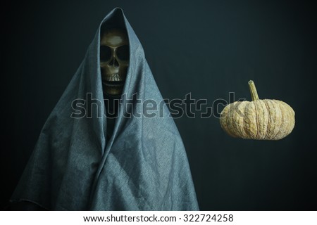 Halloween concept and background, Messenger of death with pumpkin in Halloween, Ghost with black background.