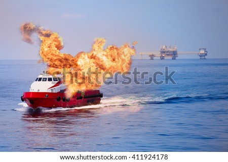 Fire burning on the boat in offshore oil and gas industry, emergency case and firefighter working for protection boat and working area.