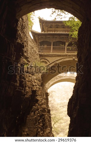 temple and bridge over a deep canyon in China