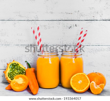 Orange smoothie on rustic background