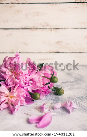 Peonies on rustic wooden background