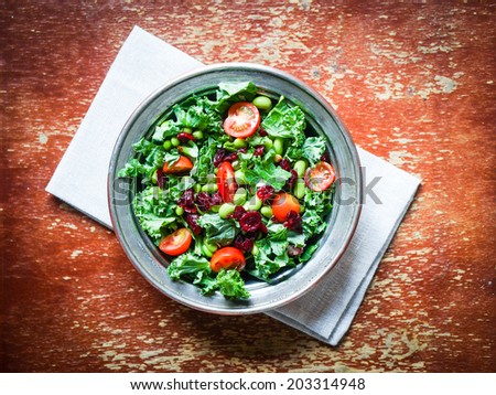 Kale and edamame salad on rustic background