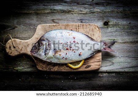 Fresh sea bream on wooden board