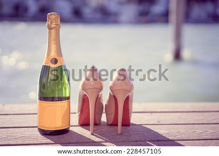 Fashion shoes and champagne near the ocean