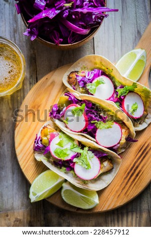 Fish tacoes on wooden background