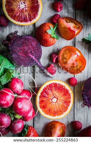 Red fruits and vegetables on wooden background