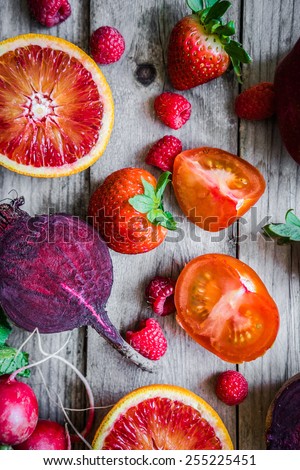 Red fruits and vegetables on wooden background