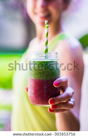 Fitness girl with colorful smoothie