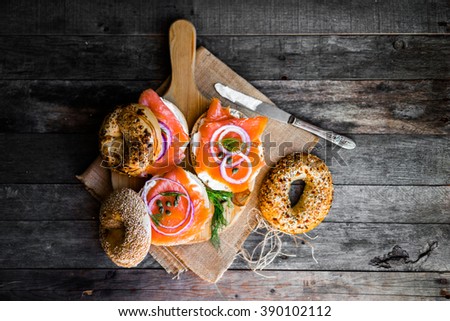 Bagels with cream cheese and smoked salmon on rustic wooden background