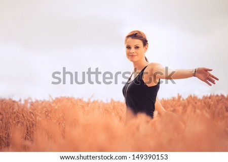 Beautiful young woman in nature feeling happy and free. With a lot of copy space.