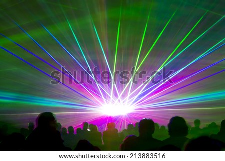 Laser show rays. Very colorful show with a crowd silhouette and great laser ray