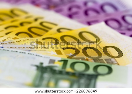 Stack of money with 100 focused 200 and 500 euro banknotes. Perfect for illustrating e.g. wealth, lottery prizes or banking crises. What is your dream?