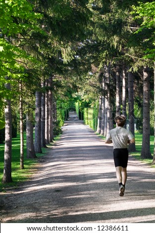 Jogging - Athletic man running in park