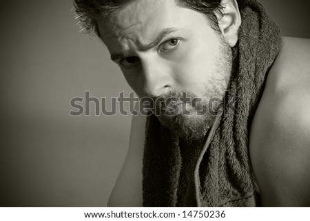 After workout: tired looking man with towel around his neck